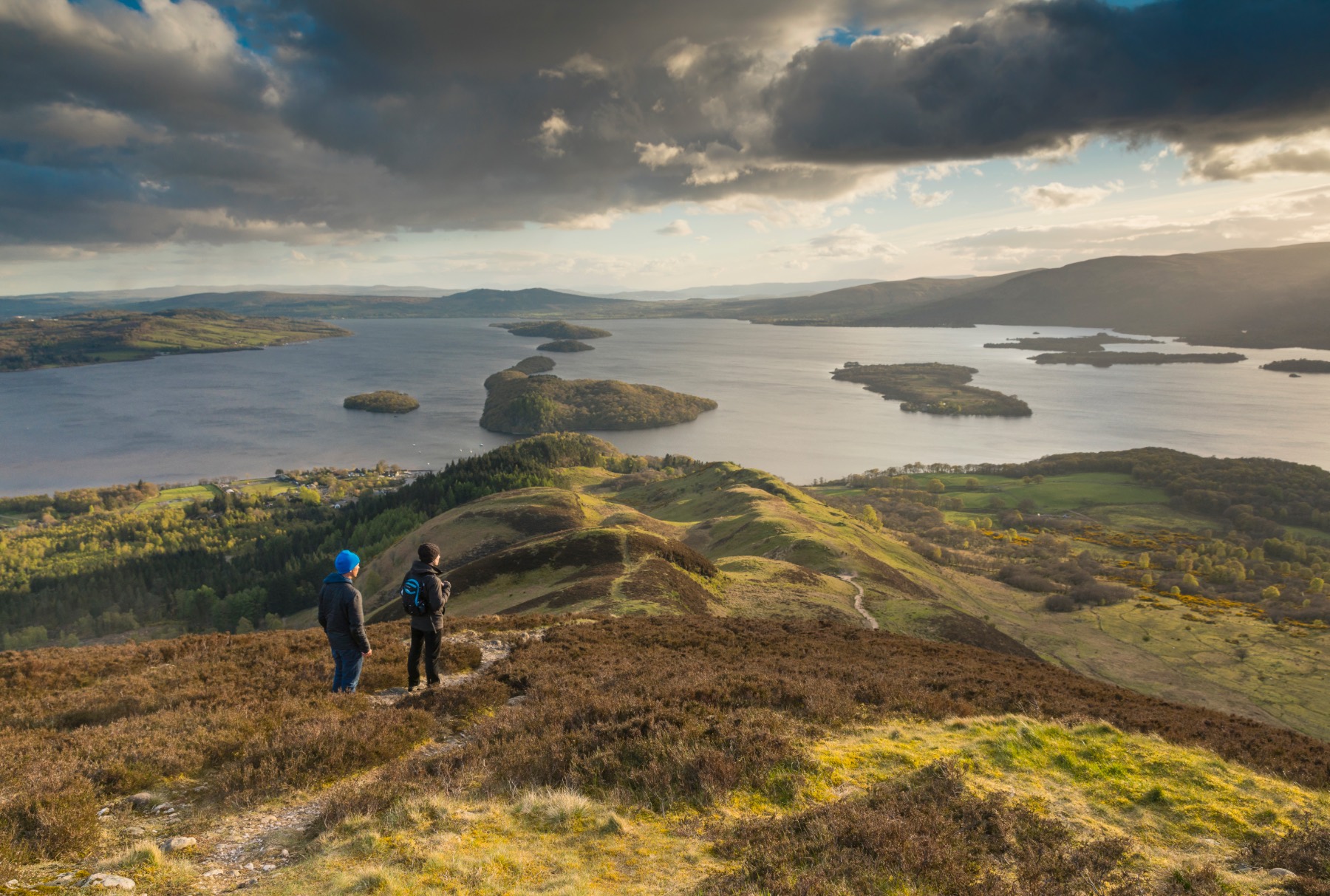 Two friends view Loch Lomond from Conic Hill